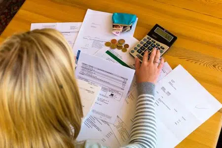 “Sovraindebitamento e finanza sostenibile” con Confconsumatori e Università di Siena Sovraindebitamento, donna con fatture, bollette e calcolatrice