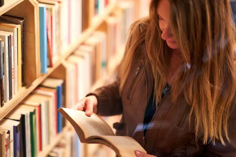 Biblioteca di San Quirico d’Orcia, continua la crescita Ragazza che legge in biblioteca